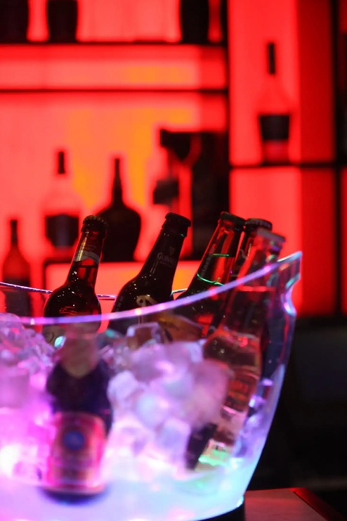 Beer bottles in an ice bowl.