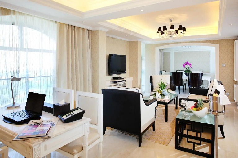 Settee, TV, work desk and dining table in the Chairman Suite.