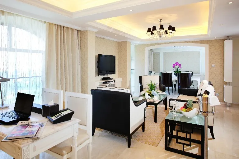 Settee, TV, work desk and dining table in the Chairman Suite.