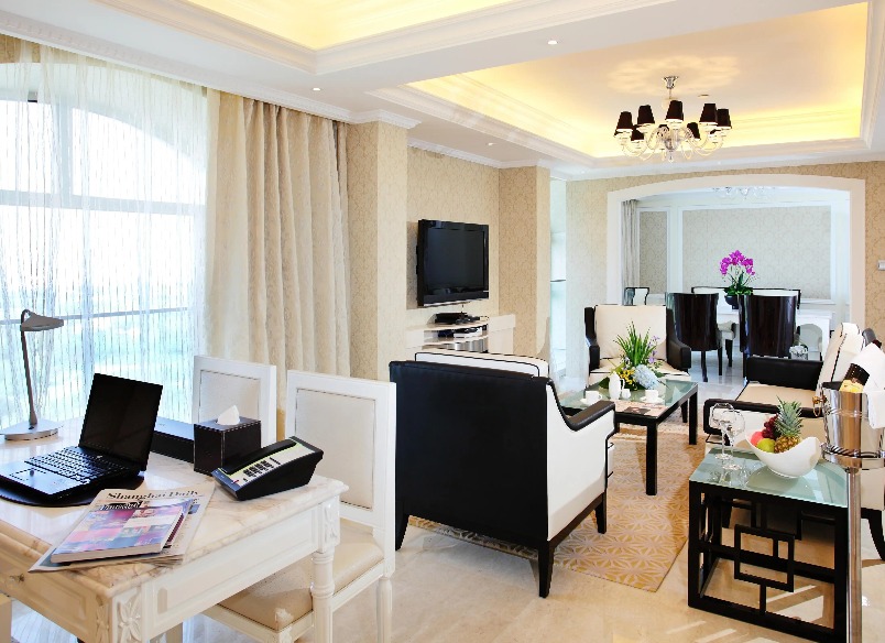 Settee, TV, work desk and dining table in the Chairman Suite.