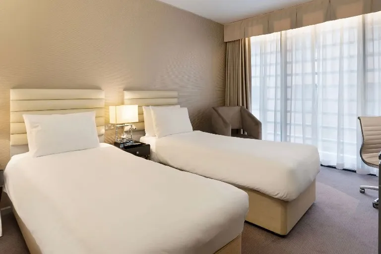 Twin Beds and chair in Deluxe Twin at Dorsett Shepherds Bush London.