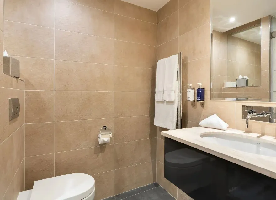 A towel rack next to a single vanity at Dorsett Shepherd Bush London.