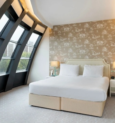 King-size bed with bedside tables in Dorsett Suite, London.