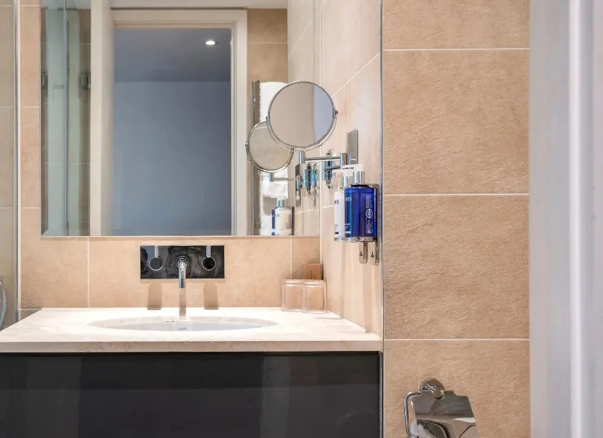 Single vanity with shaving and shower amenities at Dorsett Shepherd Bush