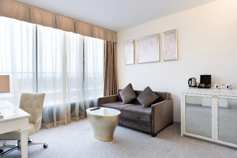 Sofa, work desk and coffee table by the window in the Suite.