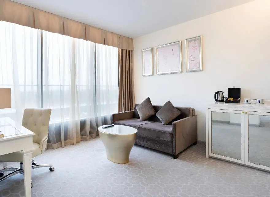 Sofa, work desk and coffee table by the window in the Suite.