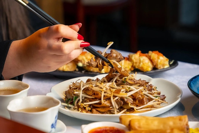 Chopsticks holding Beef Chow Fun at Shikumen, London.