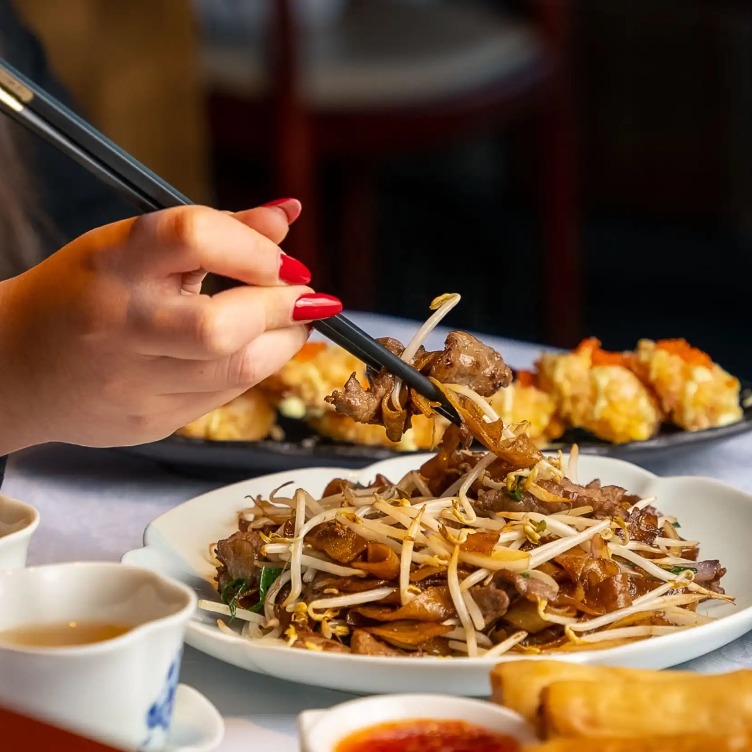 Chopsticks holding Beef Chow Fun at Shikumen, London.