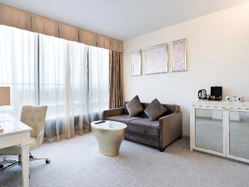 Sofa, work desk and coffee table by the window in the Suite.