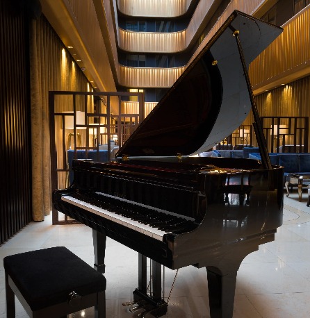 A black grand piano at  Dorsett Shepherds Bush London Hotel lobby.