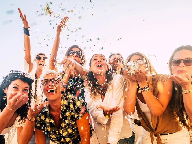 A group of women celebrating with confetti.