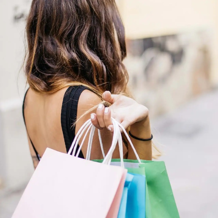 A woman holding shopping bags.