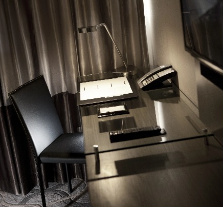 A work desk and a TV in a Dorsett Singapore Hotel room.