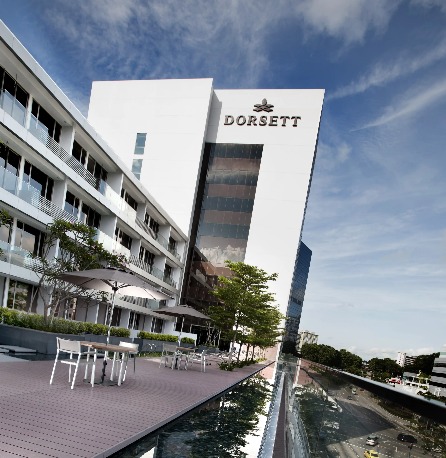 Exterior of Dorsett Singapore Hotel with garden chairs.