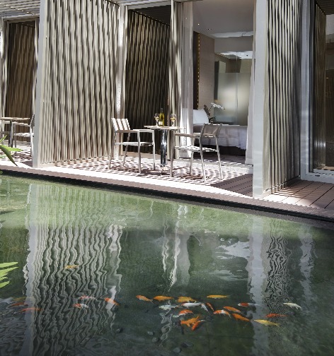 A bistro set in the balcony of the Balcony Room at Dorsett Singapore.