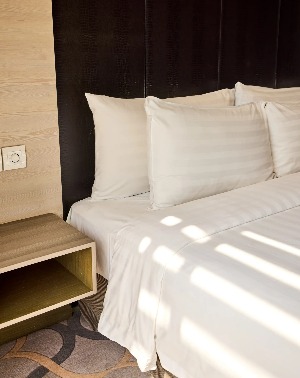 A bedside cabinet in a Dorsett Singapore Hotel bedroom.