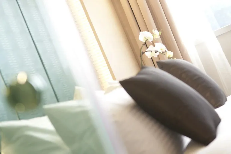 Grey pillows in a Dorsett Singapore Hotel bedroom.