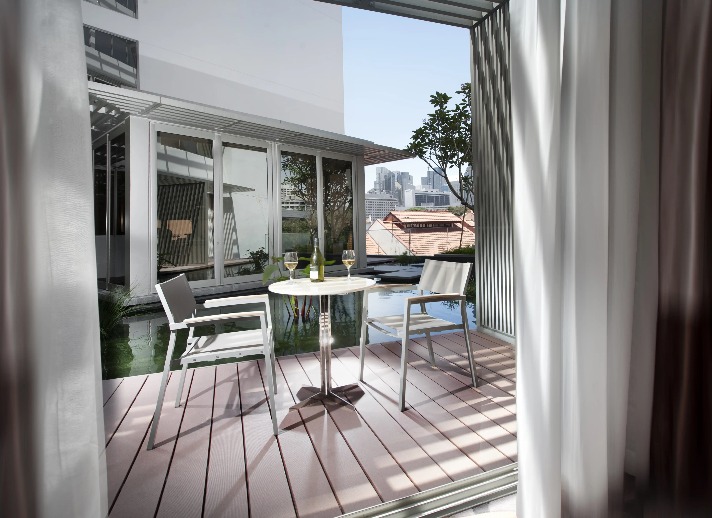 A bistro set on the balcony of the Balcony Room by the Koi Pond.