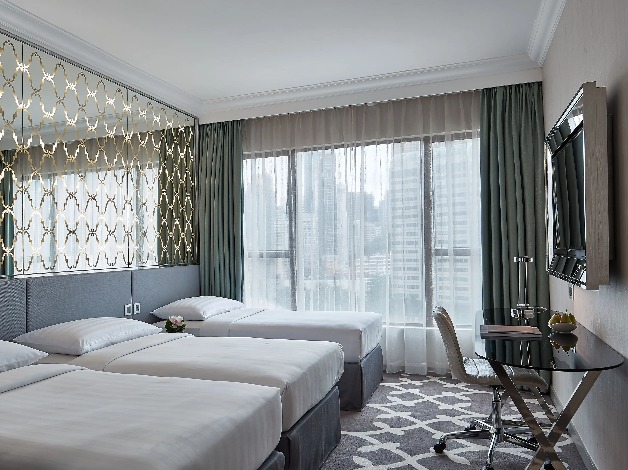 Three single beds in the Deluxe Triple Room at Dorsett Wanchai Hong Kong