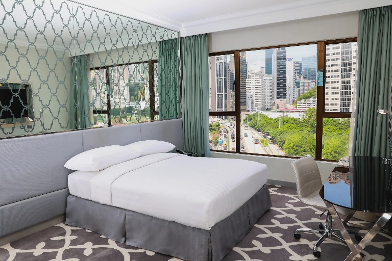 Queen size bed in Premier Causeway Bay City View Room at Dorsett Wanchai