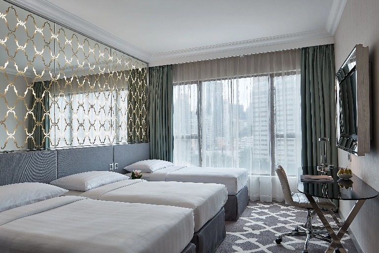 Three single beds in the Deluxe Triple Room at Dorsett Wanchai Hong Kong