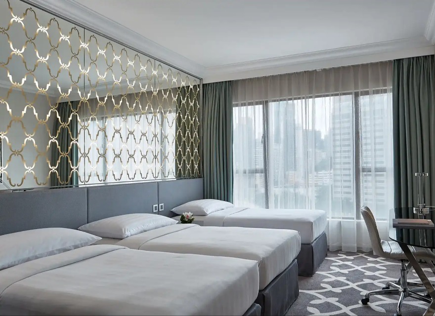 Three single beds in the Deluxe Triple Room at Dorsett Wanchai Hong Kong