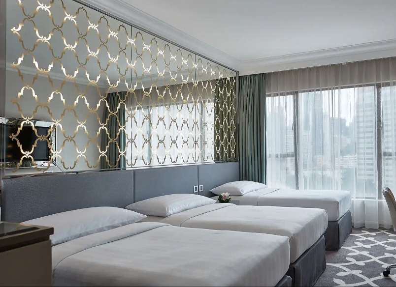 Three single beds in the Deluxe Triple Room at Dorsett Wanchai Hong Kong