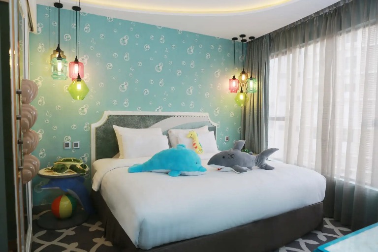 King size bed in the Ocean Suite with Dolphin Toys at Dorsett Wanchai