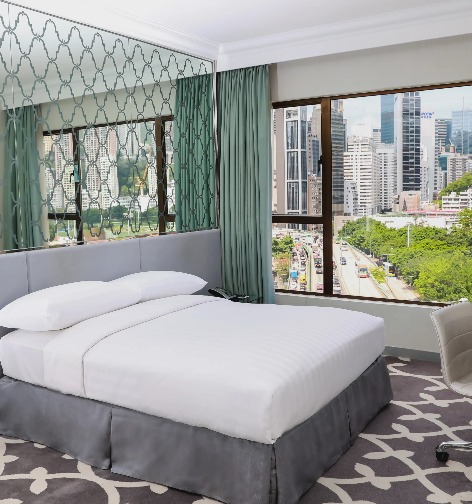 Queen size bed in Premier Causeway Bay City View Room at Dorsett Wanchai