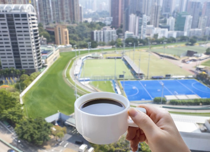 A lady enjoys in-room coffee at Dorsett Wanchai Hotel Room