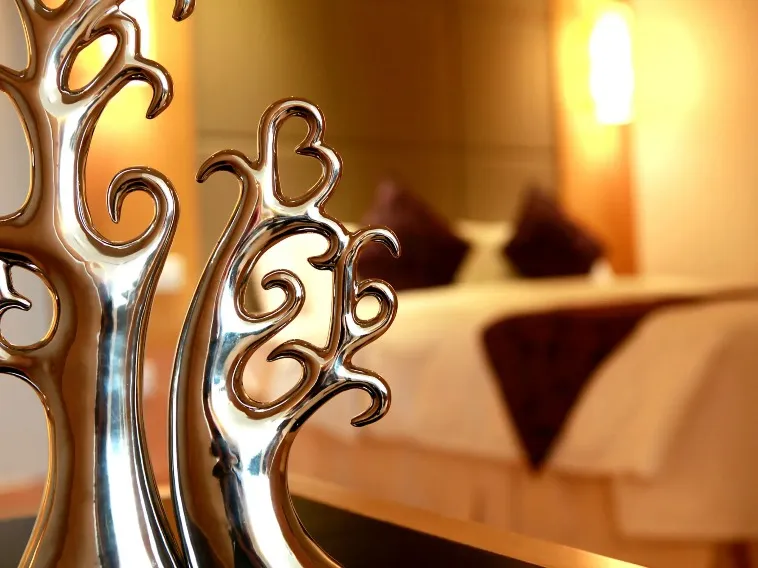 Silver tree sculptures by the bed in a Dorsett Wuhan Hotel Room.