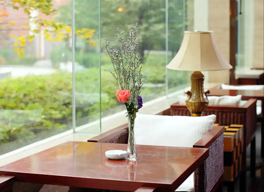 A vase on a table by the window at Lushan Resort.