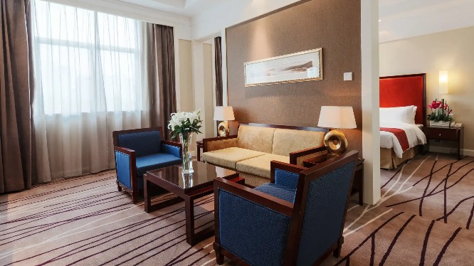 Sofa and coffee table next to the bedroom in the Lushan Resort Suite.