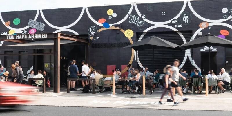 Black and multi-coloured cafe on the street in Brunswick